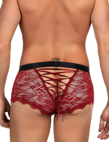 a man in a red underwear with a black tie